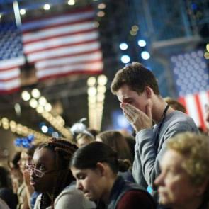 A devastated Clinton supporter buries his head in his hands