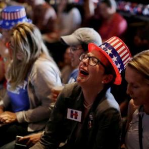 A Clinton supporter reacts as Trump lead grows