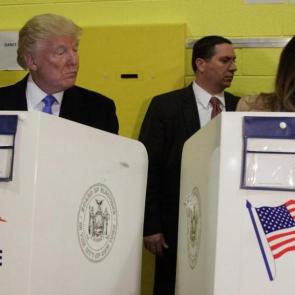 Republican presidential candidate Donald Trump looks at his wife Melania as they cast their votes at PS-59 