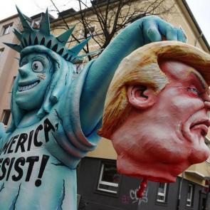A Carnival float depicting President Trump and the Statue of Liberty waits in