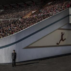 North Korea by Roger Turesson, Dagens Nyheter. Nominee, Contemporary Issues Singles. A crowd awaits the start of the Pyongyang Marathon at the Kim Il-sung Stadium, while an official guards the exit, in Pyongyang, North Korea.