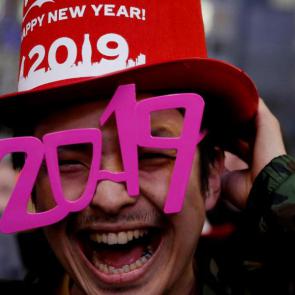 A man wears glasses shaped as the year 2019 as he attends a new year countdown event at Shibuya crossing in Tokyo, Japan, December 31, 2018. Reuters
