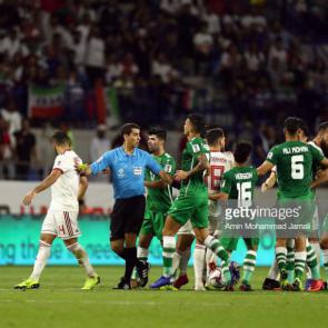 DUBAI, UNITED ARAB EMIRATES - JANUARY 16: Players from Iran (white) and Iraq (green) react during the AFC Asian Cup Group D match between Iran and Iraq at Al Maktoum Stadium on January 16, 2019 in Dubai, United Arab Emirates. (Photo by Amin Mohammad Jamali/Getty Images)