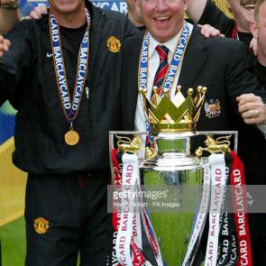 Manchester United manager Sir Alex Gerguson (R) and first team coach Carlos Queroz with the Premiership trophy after the 2-1 win over Everton