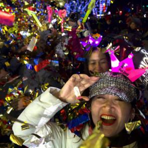 People celebrate the new year near the 2022 Beijing Winter Olympic headquarters.Ng Han Guan/AP