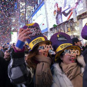 People celebrate as confetti falls in New York s Times Square.Craig Ruttle/AP